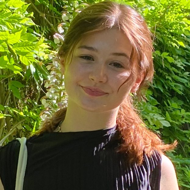 a woman standing in front of a tree